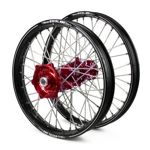 Pair of black bicycle wheels with red anodized hubs and silver spokes. Used as a product image for rims and hubs.