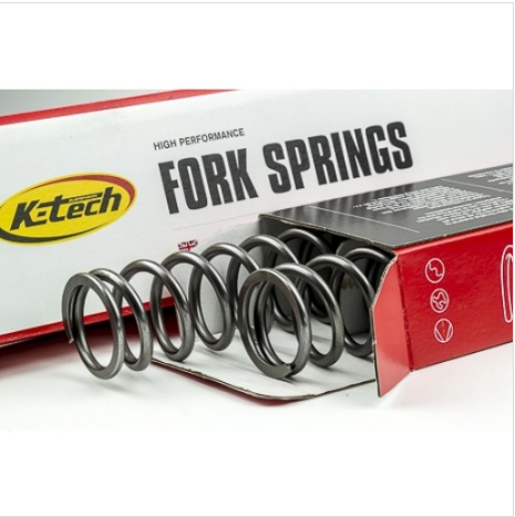 Ktech fork springs partially removed from a red-and-white box, showing a coiled metal spring