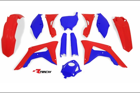 Assorted red and blue motorcycle fairing panels arranged on a white background