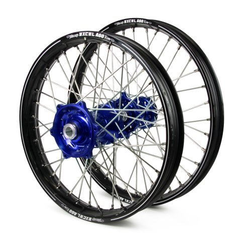 Pair of blue anodized bicycle wheels with black rims and silver spokes, stacked together for display.