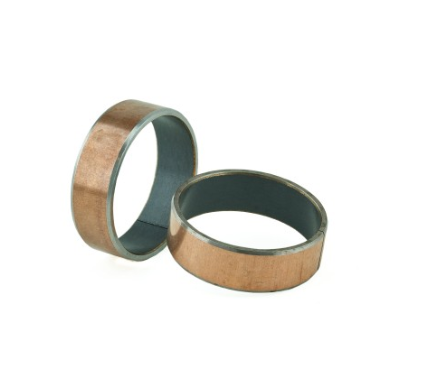 Two copper-colored metal bangles with a dark inner lining, resting on a white background.