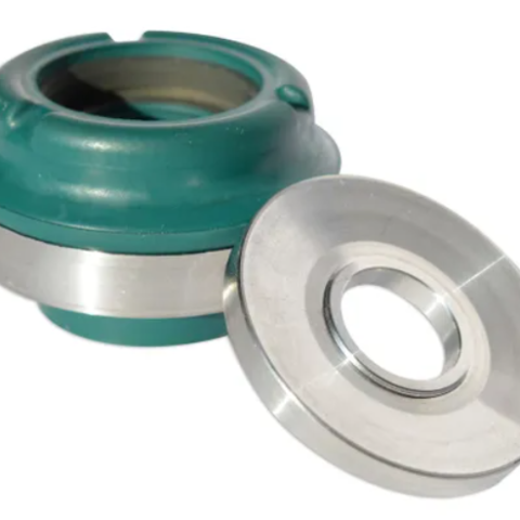 Mechanical seal component for a pump: green housing with a metal flange and seal ring beside it