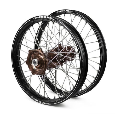 Two black bicycle wheels with brown hubs and silver spokes stacked together against a white background.