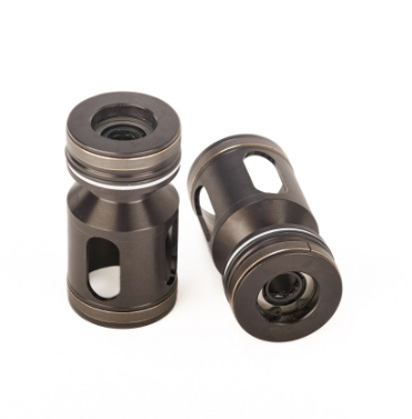 Two small metal cylindrical parts with cutouts and visible internal rings on a white background.