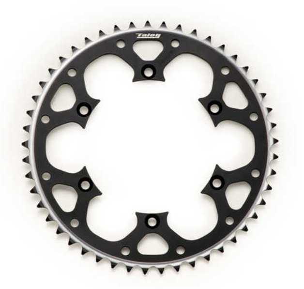 09fbbf_f6db138ec56842b4aeb2fd51e07c41fbmv2.png - Inmotion Suspension Circular bicycle chainring with jagged teeth around the edge and black cut-out spokes, centered on a white background.
