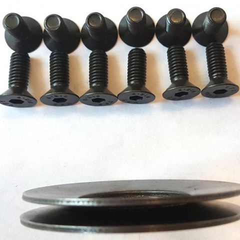Six black socket-head bolts lined up above two flat washers on a white background.