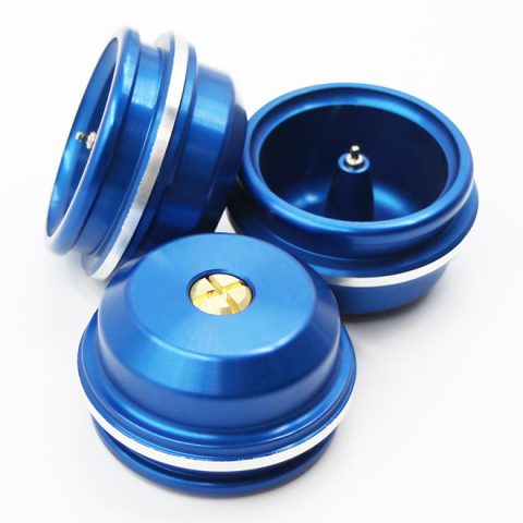 Blue aluminum yo-yo halves and bearing pieces arranged together, showcasing a glossy finish and silver spacers.