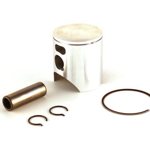 Metal piston with several brown piston rings scattered on a white surface.