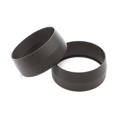 Two black circular rings with hollow centers resting on a white background.